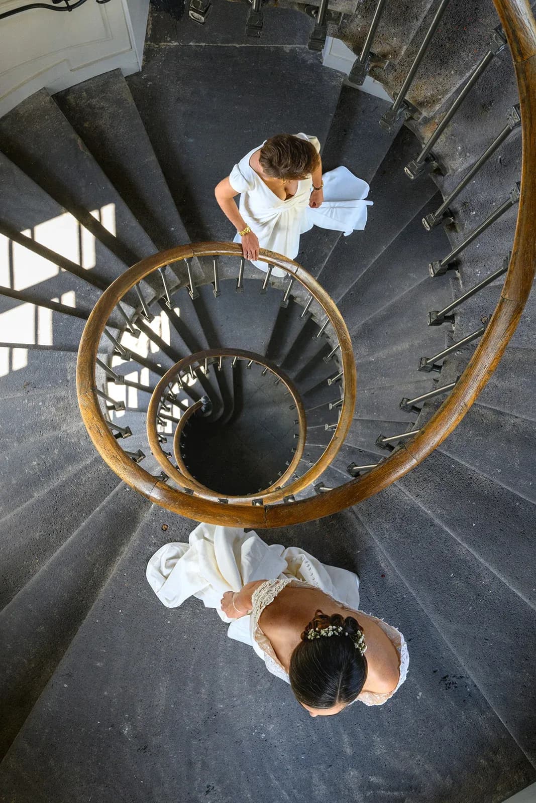 Vita et Charlotte descendent l'escalier en colimaçon le jour de leur mariage