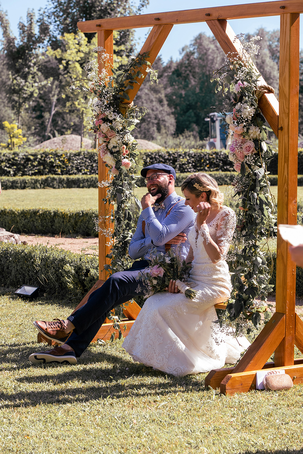 A married couple sitting on a wooden swing